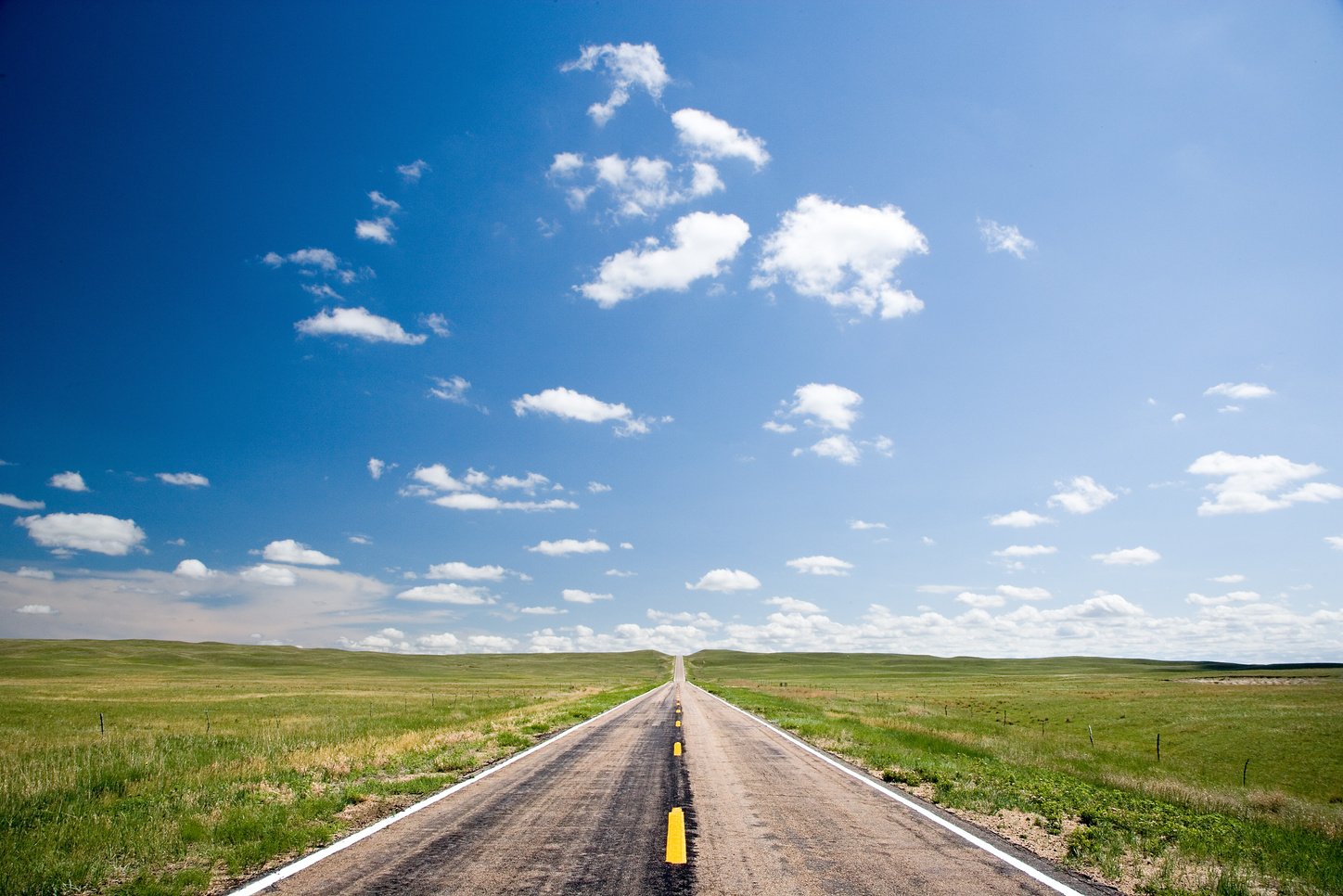 Road through flat expanse of rangeland