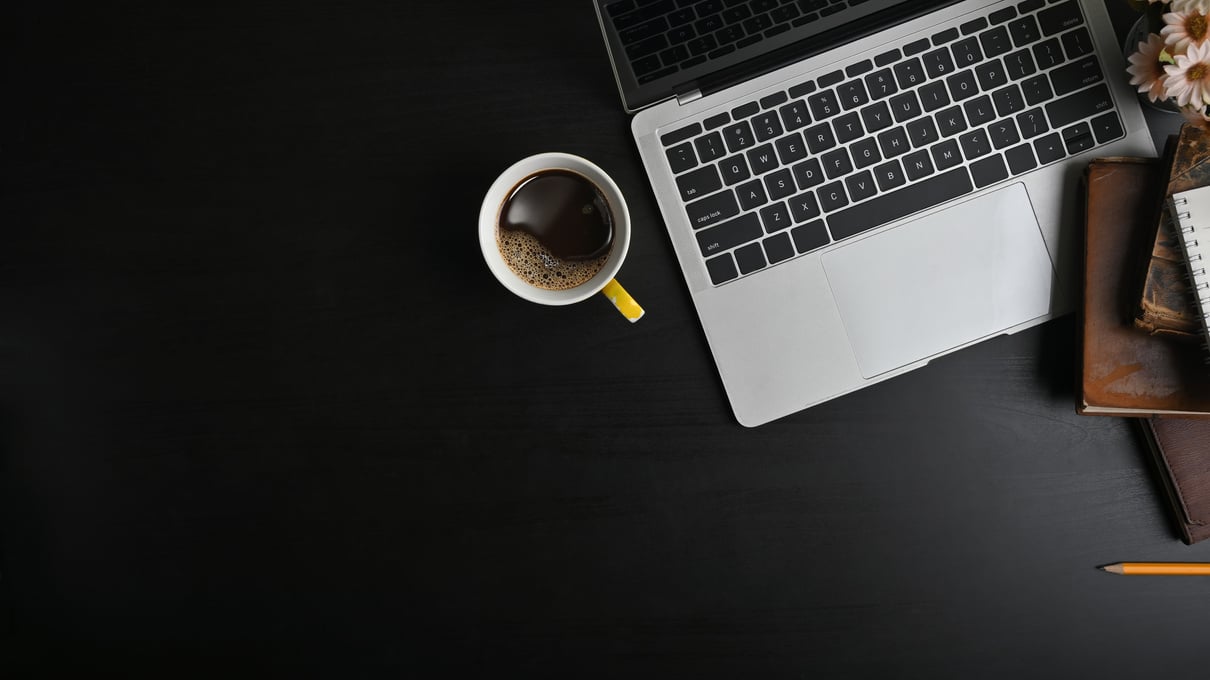 Dark Office Space with Laptop and Coffee Flatlay